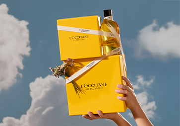 Woman holding L'OCCITANE gift box, L'OCCITANE unisex gifting