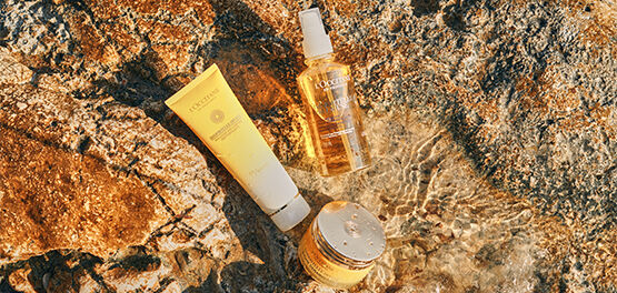 The image shows L'OCCITANE's Immortelle Divine Cream, L'OCCITANE Immortelle Divine Foaming Cleansing Cream and L'OCCITANE Immortelle Divine cleanser