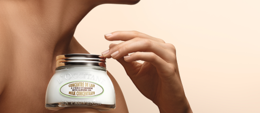 Woman holding L'OCCITANE Shea Ultra Rich Body Cream, Organic Shea Butter, Fair Trade, Burkina Faso, Natural Remedy, Comforting & Nourishing