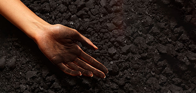 Woman's hand covered with coal, L'OCCITANE Uses Sustainable Methods of Production, Cauldrons heated with Steam
