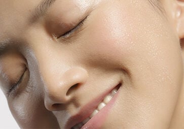This image shows the face of a woman smiling