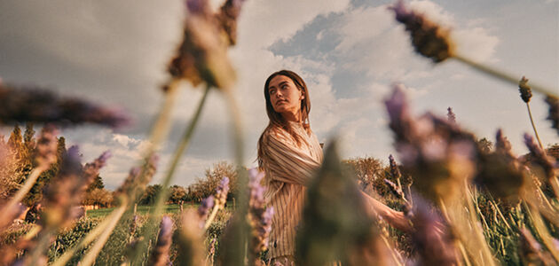 Image showing a woman walking through a lavender field in Provence