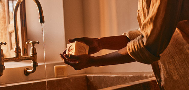 A woman washing her hands using L'OCCITANE Bonne mere Extra Pure Soap