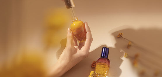 The image shows the L'OCCITANE Immortelle Divine Serum and L'OCCITANE Immortelle Reset Overnight serum