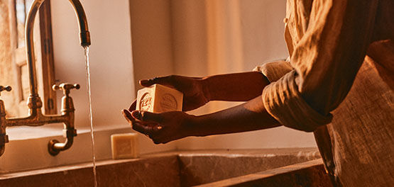 A woman washing her hands using L'OCCITANE Bonne mere Extra Pure Soap
