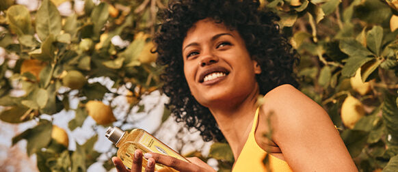 Woman holding L'OCCITANE Citrus Verbena Shampoo