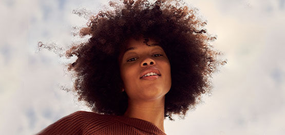 The image shows a young woman smiling