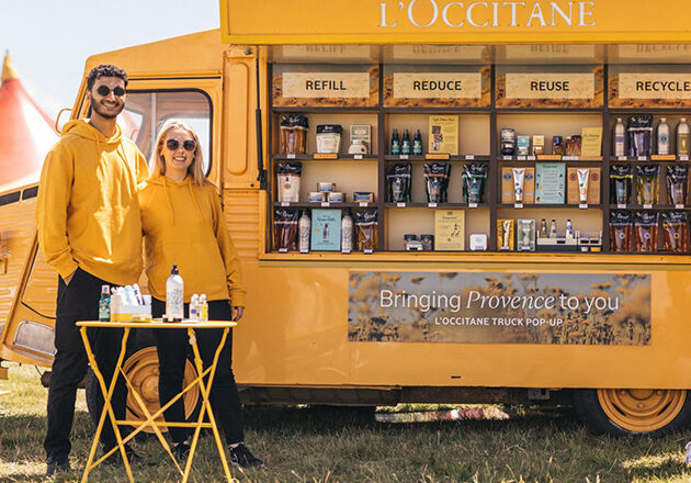 L'OCCITANE Brand Ambassadors standing next to the iconic Yellow L'Occi Truck 