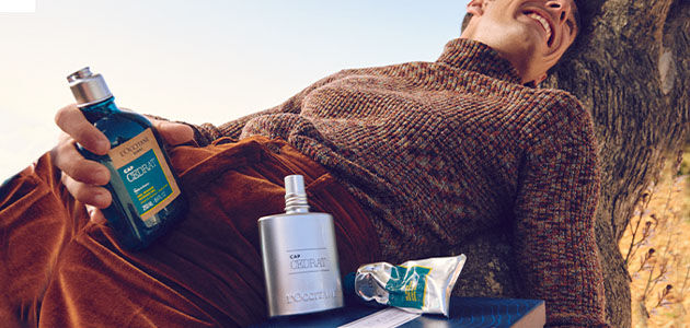 The image shows a man holding the L'OCCITA Cap Cedrat Shower Gel 