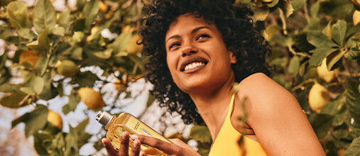 Woman holding L'OCCITANE Citrus Verbena Shampoo