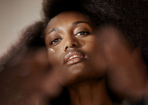 The image shows a woman looking straight at the audience
